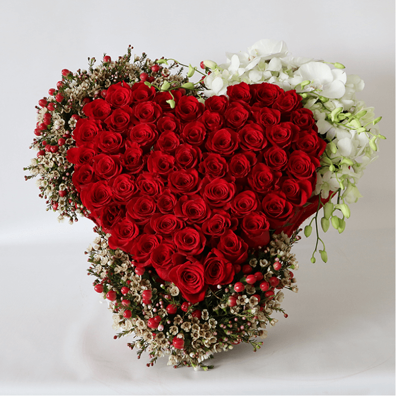 A big heart with orchids and wax flower large red rose heart surrounded by hypericum, wax flower and orchids