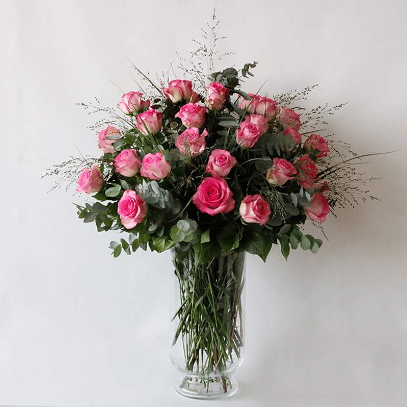 Weekly Flower Subscription 4 to 5 vases_1 Pink roses in a glass vase with grass and eucalyptus