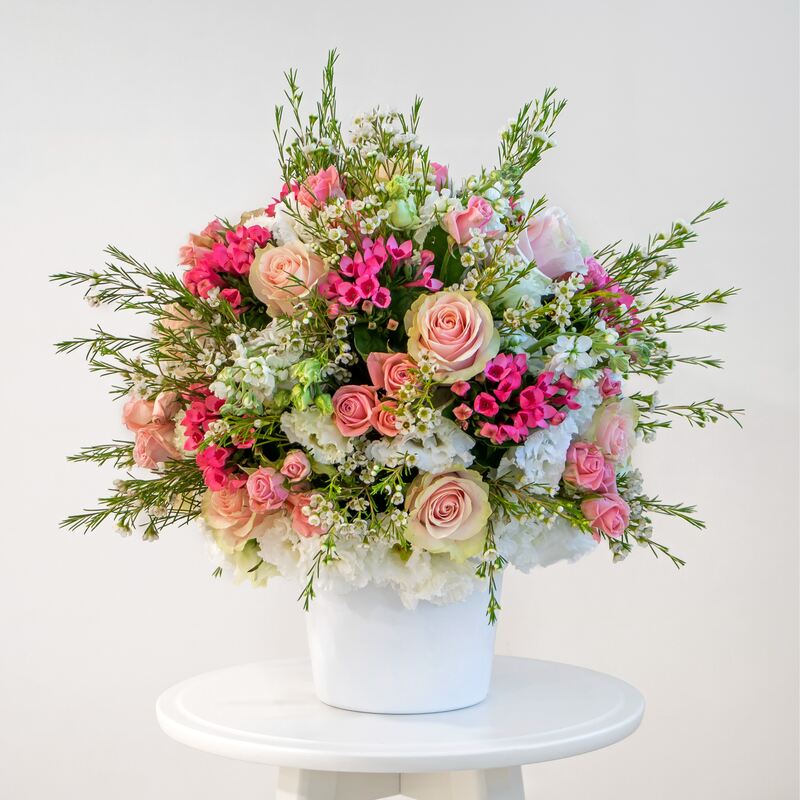 Mixed pink arrangement pink spray roses, white eustoma, wax flower, pink large headed roses and pink bouvadia