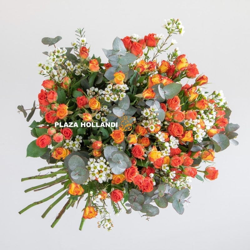 Yasmin Close up of wax flower and orange spray rose bouquet