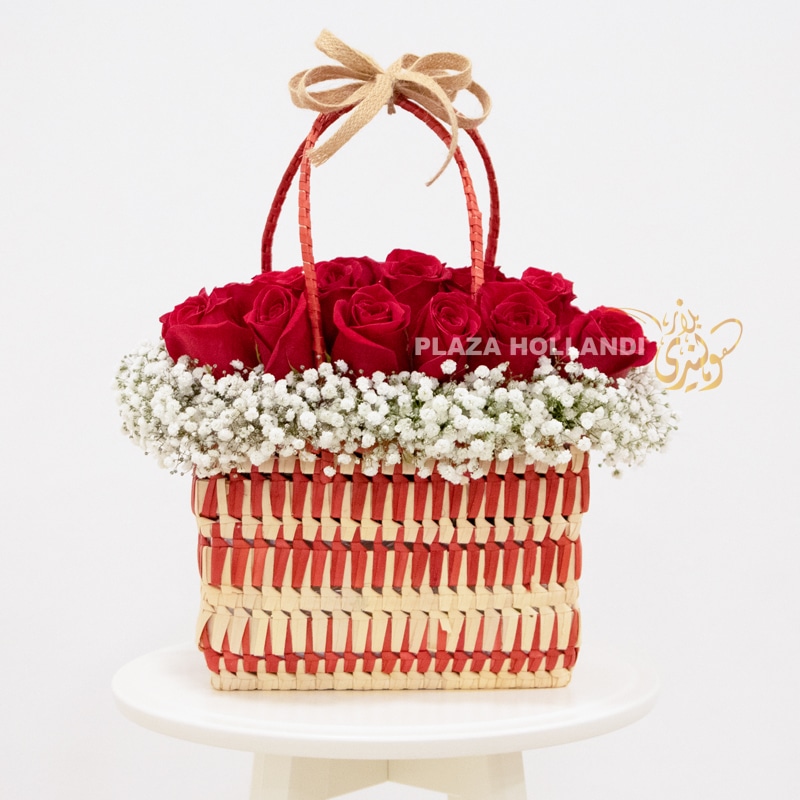 red roses in a basket Red and white basket full of roses and gypsophelia flowers