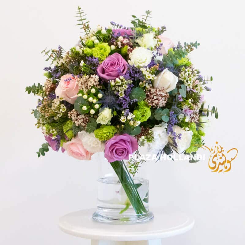 Q6 pink, purple, green and white flower arrangement in a glass vase