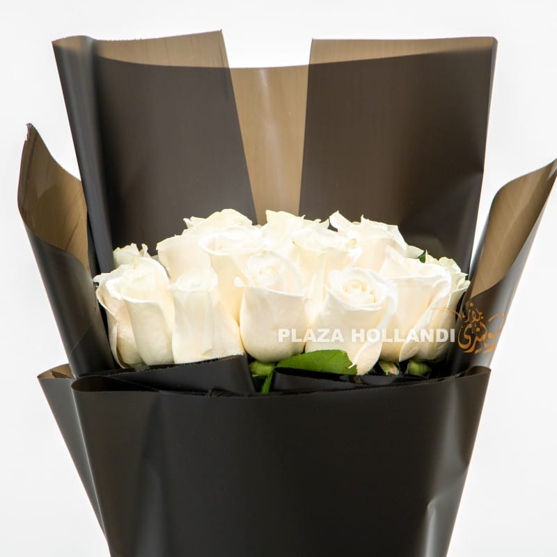 1.2 close up of white roses and black wrapping bouquet